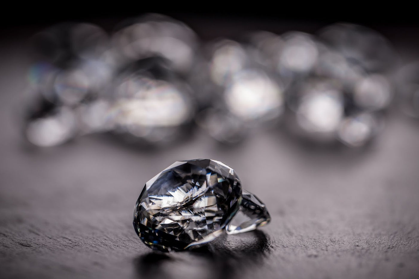 Two loose diamonds sitting on a table.