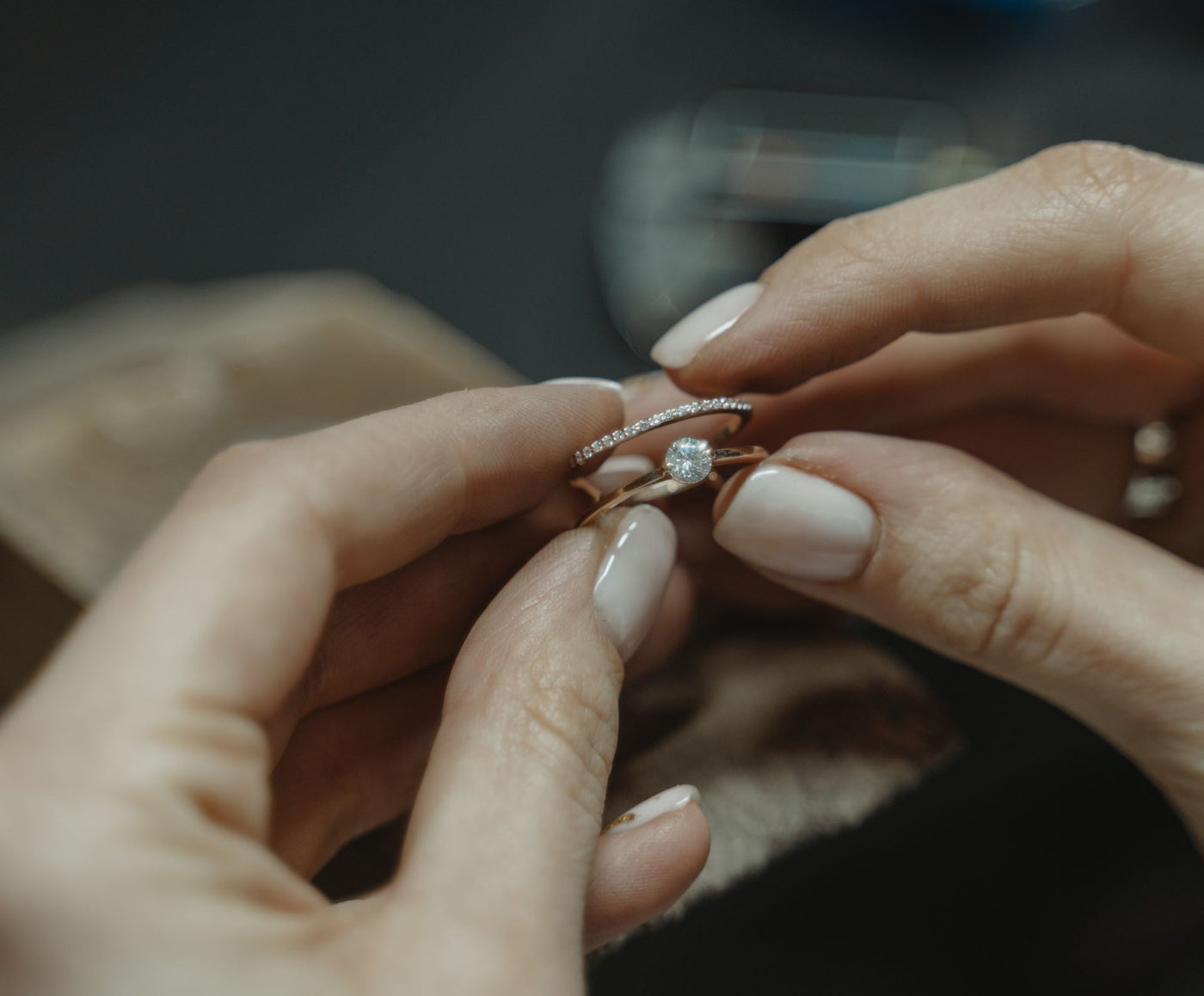 A person holding their lab grown diamond engagement ring after cleaning it by following a jewelry care guide.