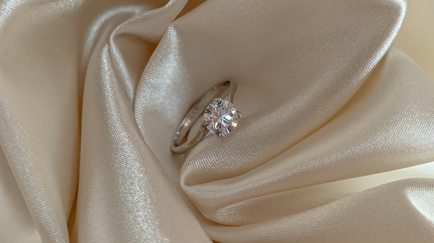 Lab-grown engagement ring on vanilla silk background.