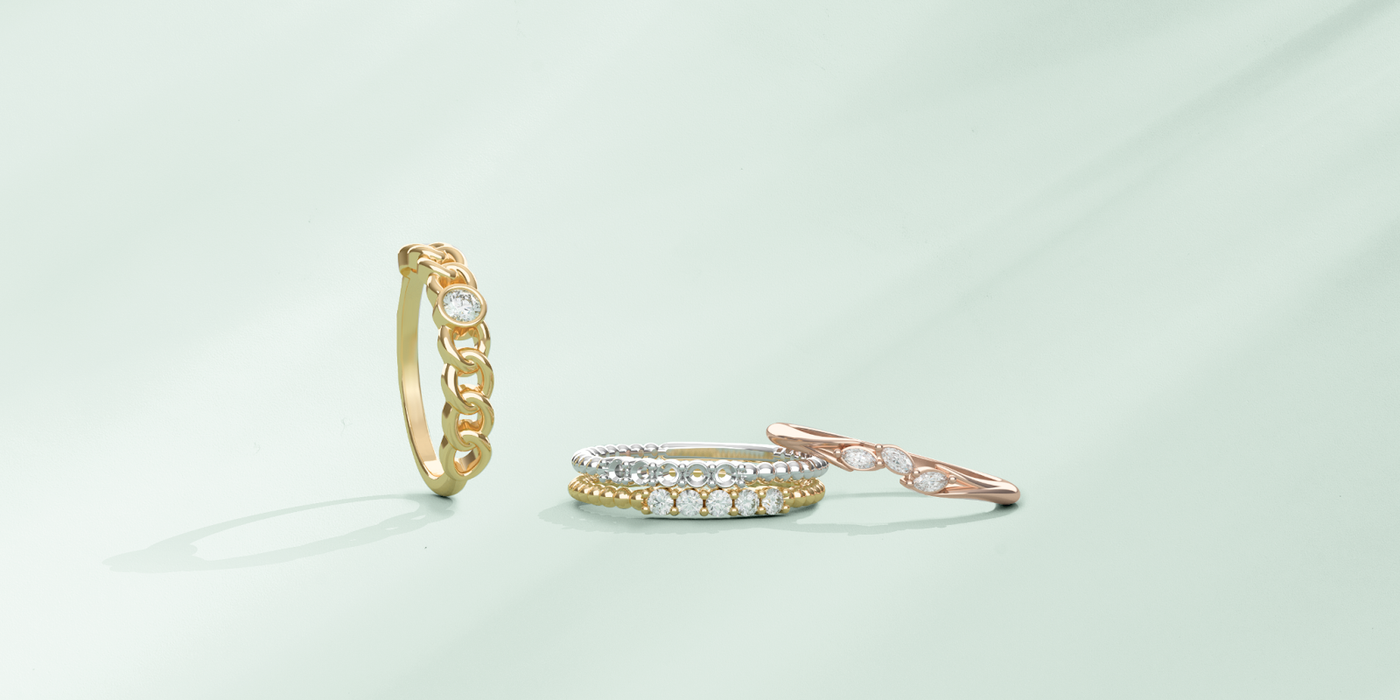 Three different types of lab-grown diamond rings, yellow gold, rose gold and white gold metal types.