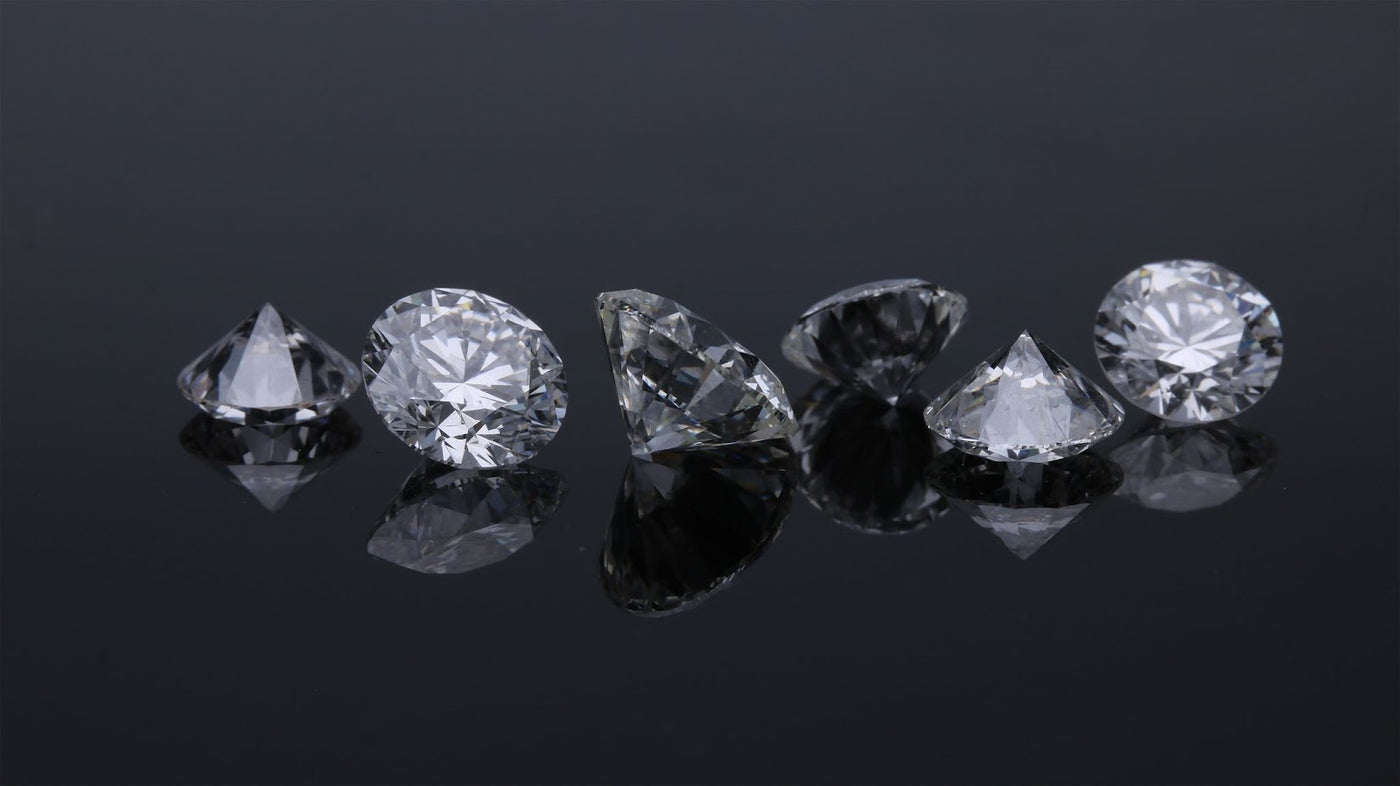 Several lab-grown white diamonds with their own anatomy & structure.