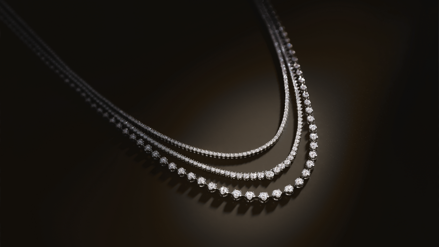 Close up of a flatlay 3 diamond tennis necklaces